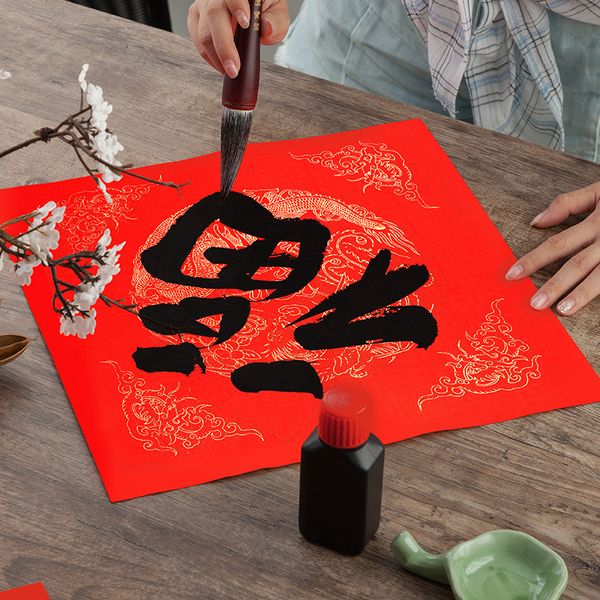 Giấy xuyến đỏ viết câu đối hình rồng phượng