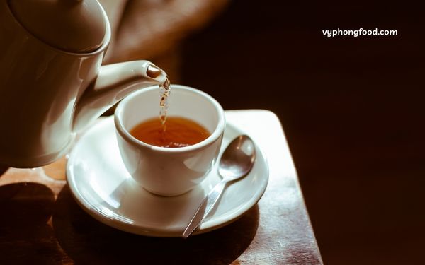 A cup of premium South African Rooibos tea served hot, showcasing its rich amber color and natural herbal aroma, known for its health-boosting antioxidants. Vyphongfood.com is the official importer of African Dawn Rooibos tea products.