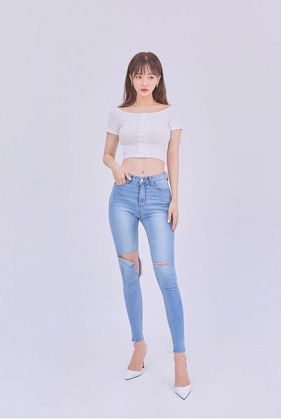 Áo croptop ôm body kết hợp với quần jean lưng cao rách gối giúp hack dáng tối đa cho người mặc.