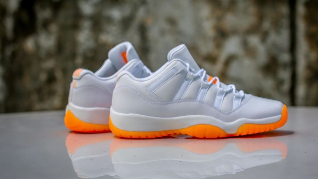 low top 11s orange and white