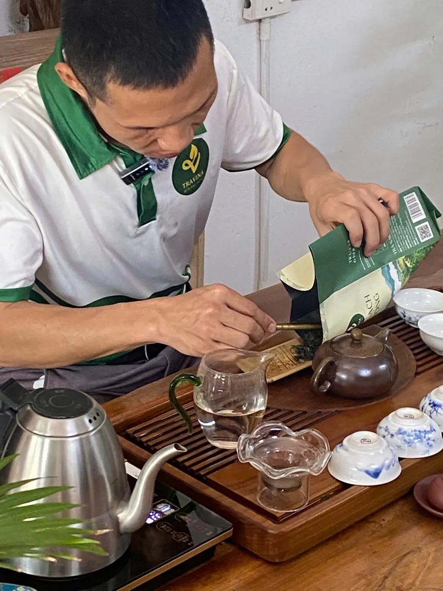 Nhân viên HTX Tâm Trà Việt pha trà bằng ấm và chén tống