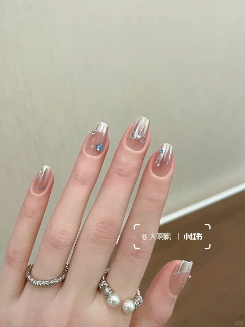 Móng tay tráng gương đẹp với điểm nhấn hình nơ dễ thương, kết hợp hài hòa giữa nét hiện đại và nữ tính