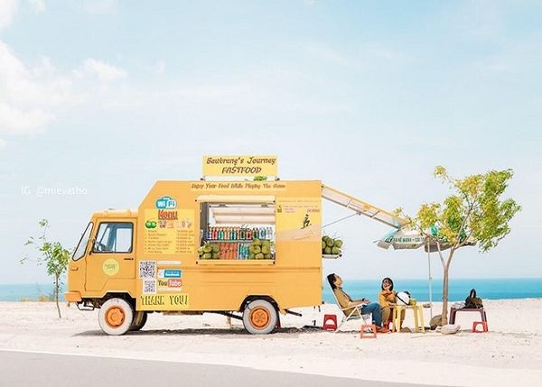 Chiếc xe màu vàng bên lề đường ven biển